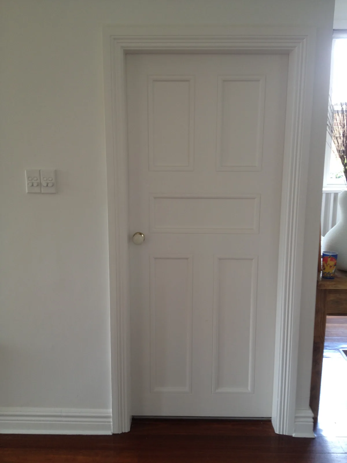 White panelled internal door with timber architraves