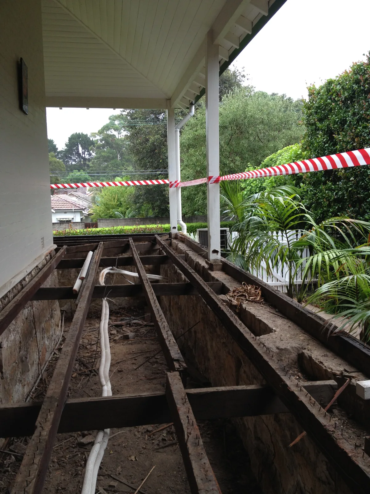 Verandah with flooring removed to expose the framing